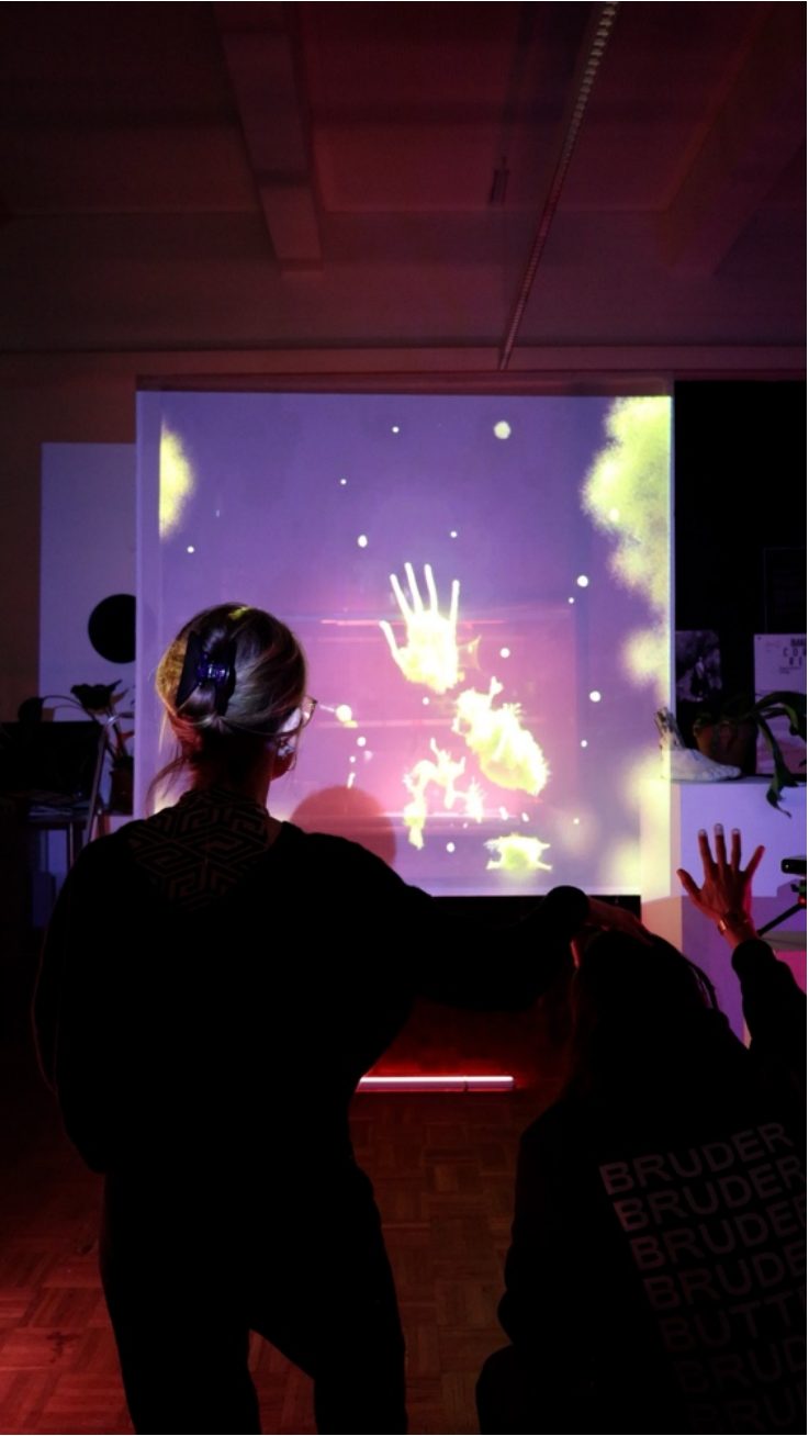 Visitors interacting with hybrid creatures on a projection